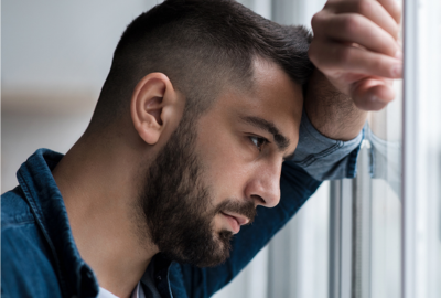 Man looking sad resting his head on his hand